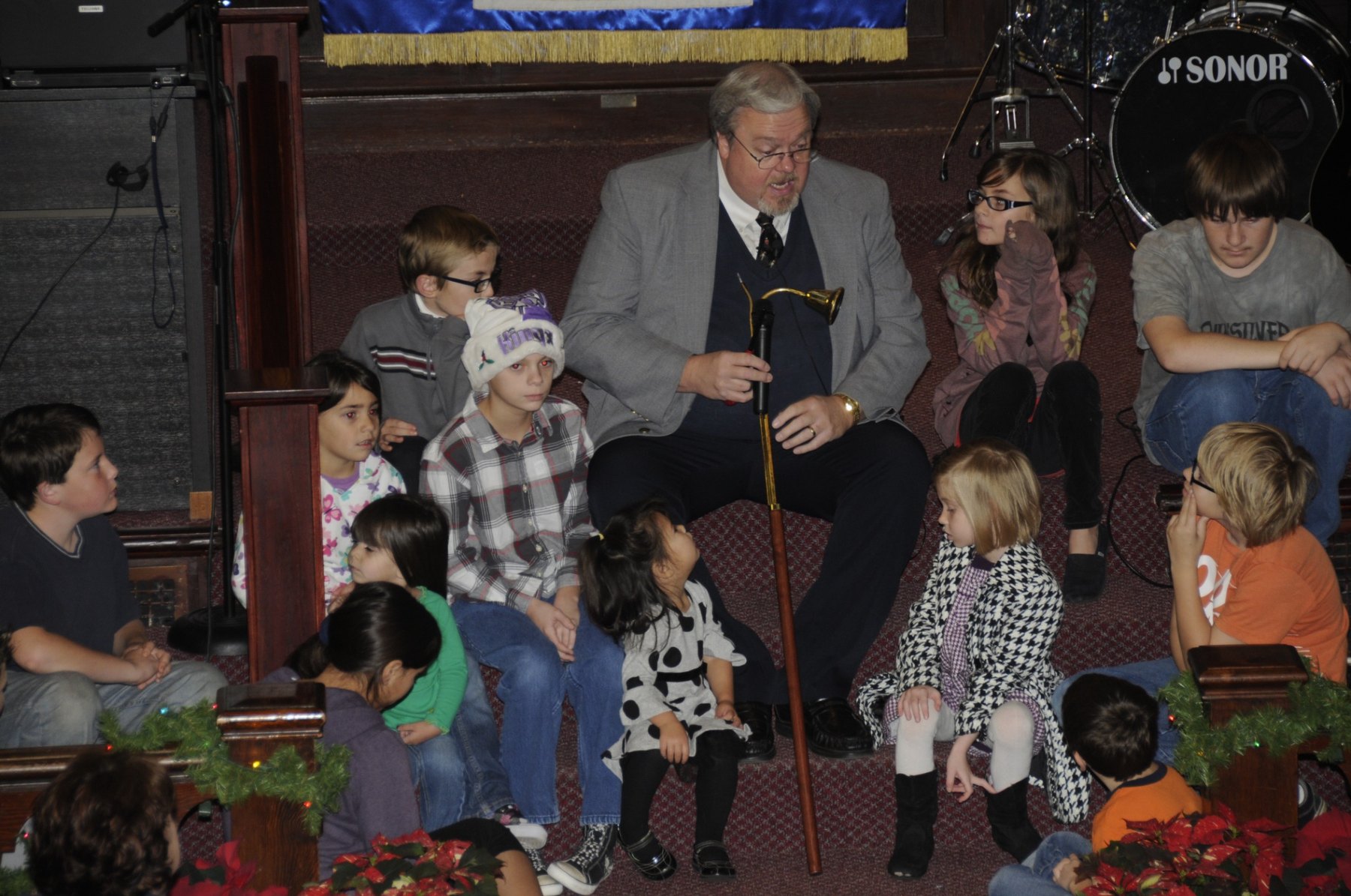 Children gathered with the pastor at the front of the sanctuary