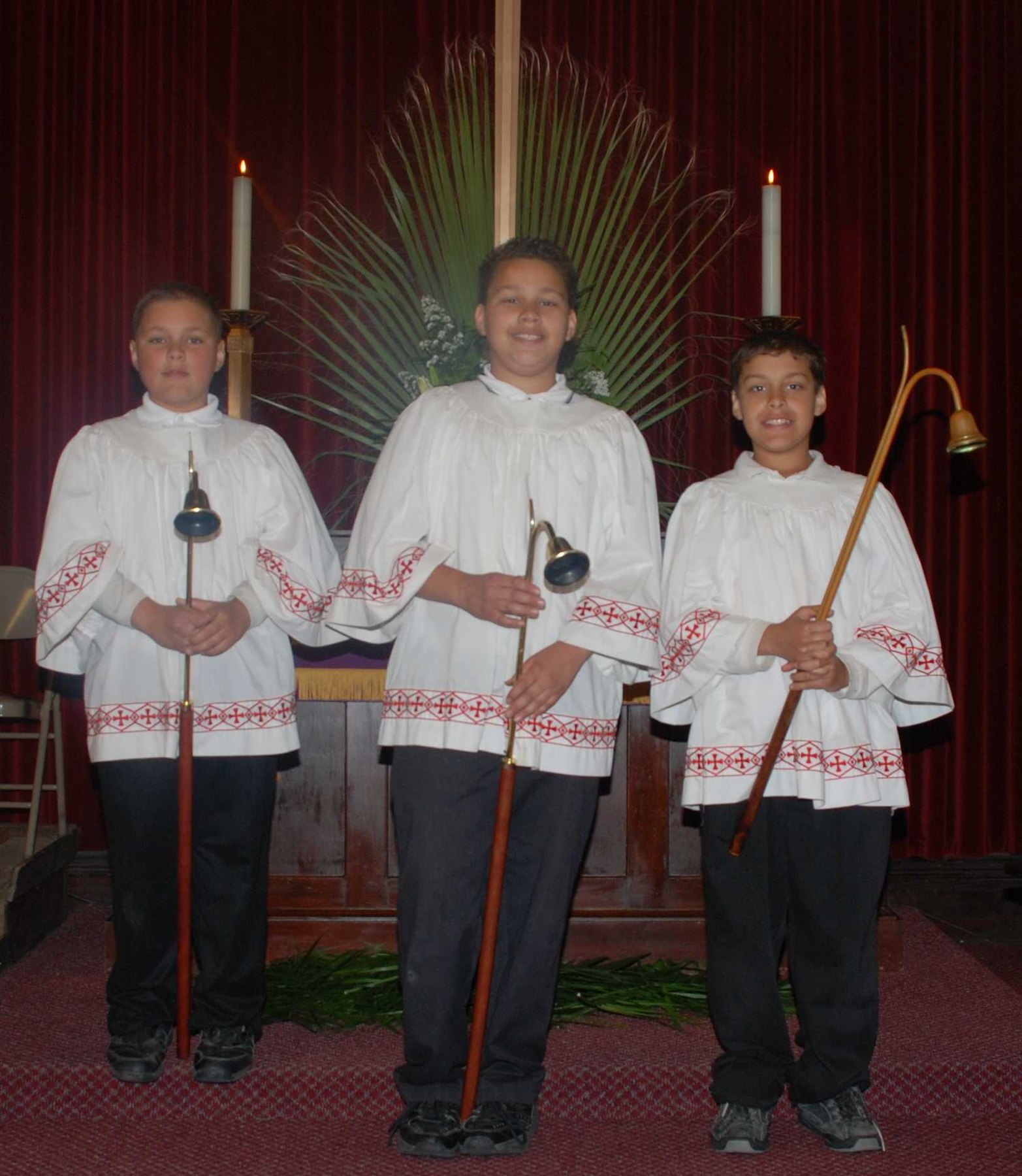 Young people serving in worship as acolytes