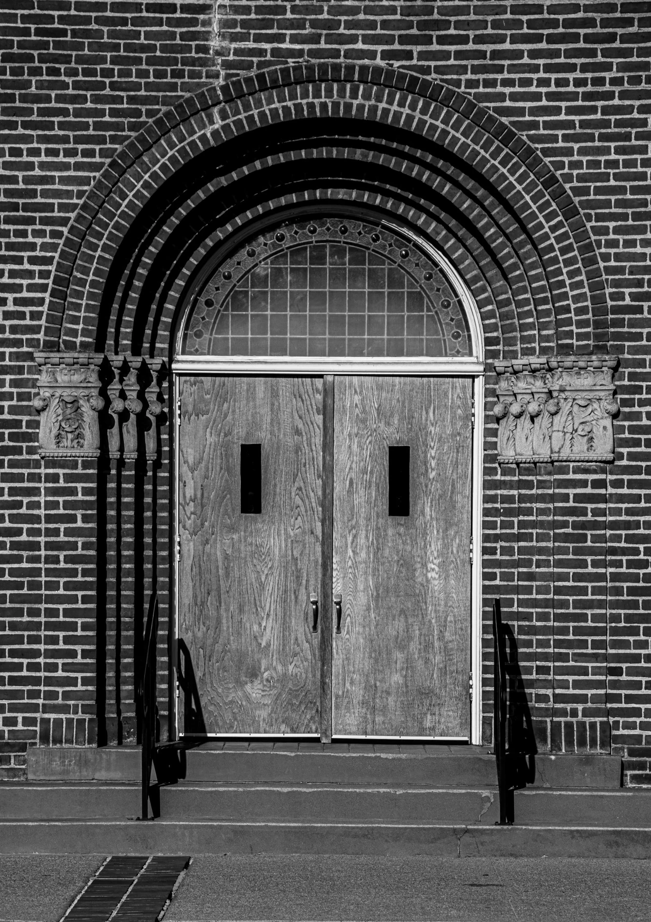 Main church doors and brick arch in 2026