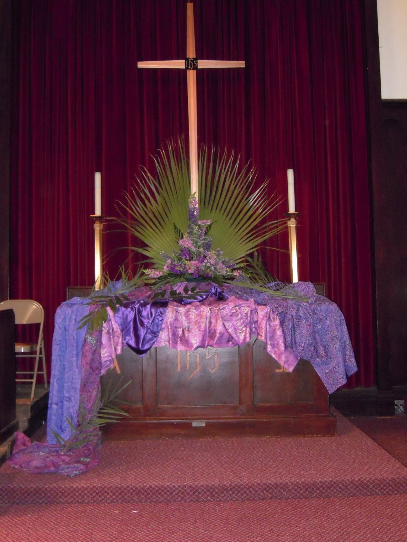 Purple, palms and flowers around the altar.